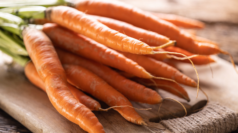 bunch of raw carrots on cutting board