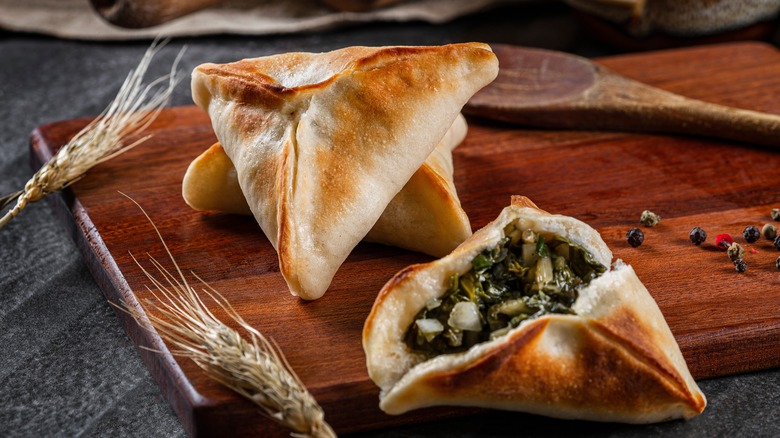 spinach fatayer on wooden board