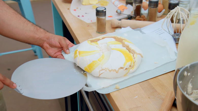 pavlova being slid on baking sheet