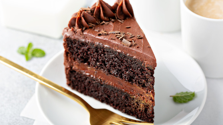 Slice of chocolate cake on a small white plate