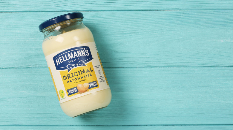 Jar of Hellmann's mayonnaise on blue background