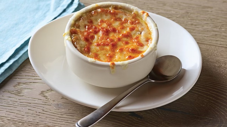 Applebee's French onion soup plated with spoon next to it