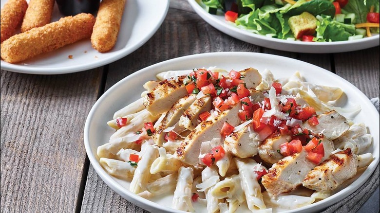 Applebee's plate of pasta with salad and mozzarella sticks