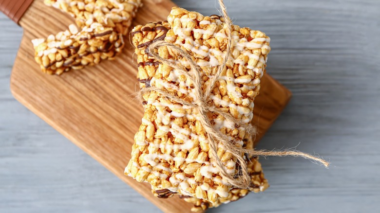 Rice Krispie treat tied with twine on cutting board