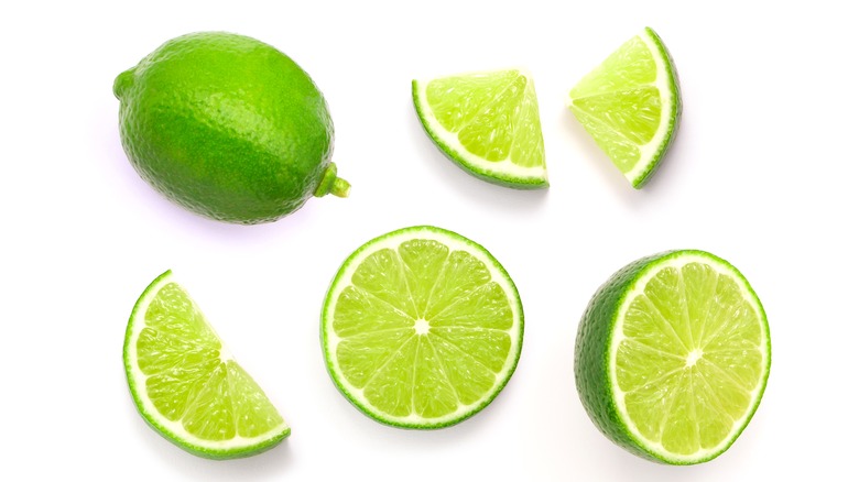 Fresh limes whole and cut