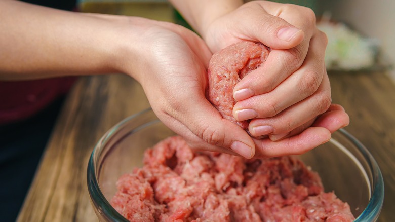 woman hands shaping meatball