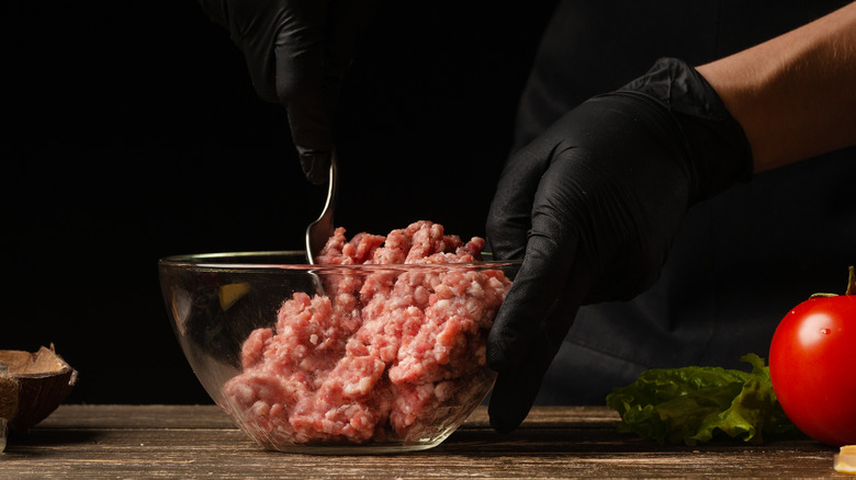 mixing raw ground burger bowl