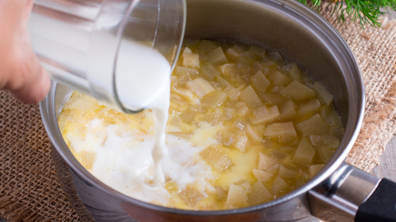 Milk pouring into potatoes