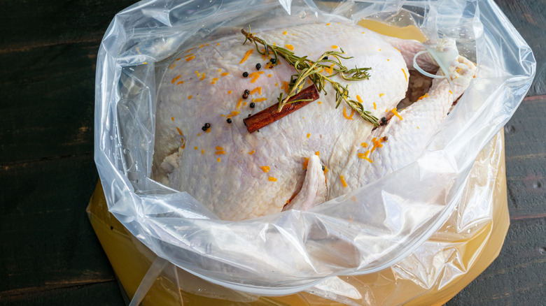 whole turkey in brining bag with spices and herbs