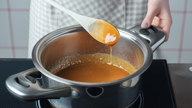 Stirring caramel with wooden spoon