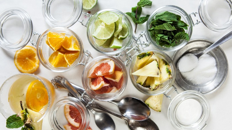 A top-down view of various cocktail ingredients in mason jars