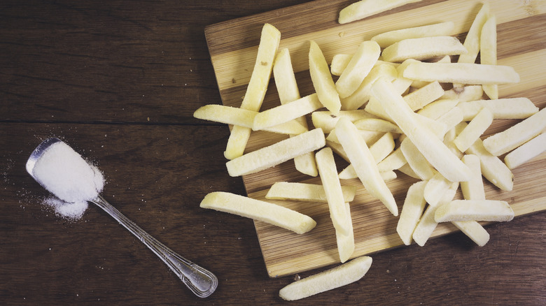 Frozen fries on cutting board