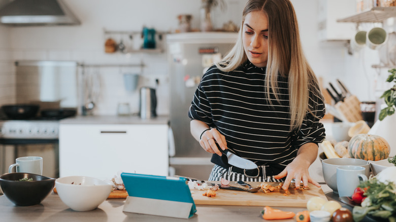 Woman cooking with tablet