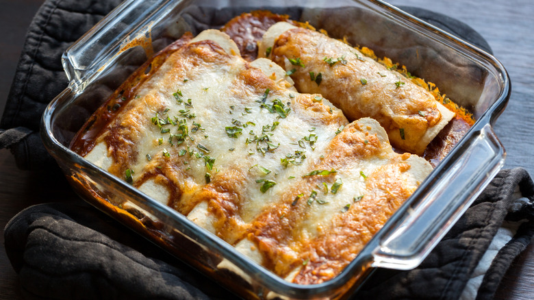 Enchiladas in sauce in dish