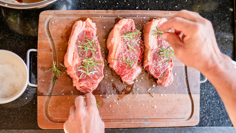 Hand salting beef on board