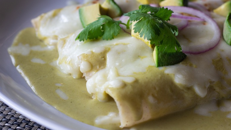 Enchiladas with avocado, cilantro, onion