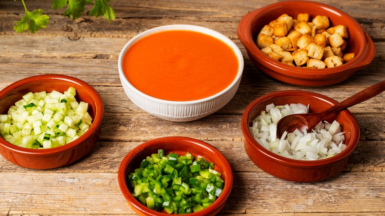 gazpacho with bowls of toppings