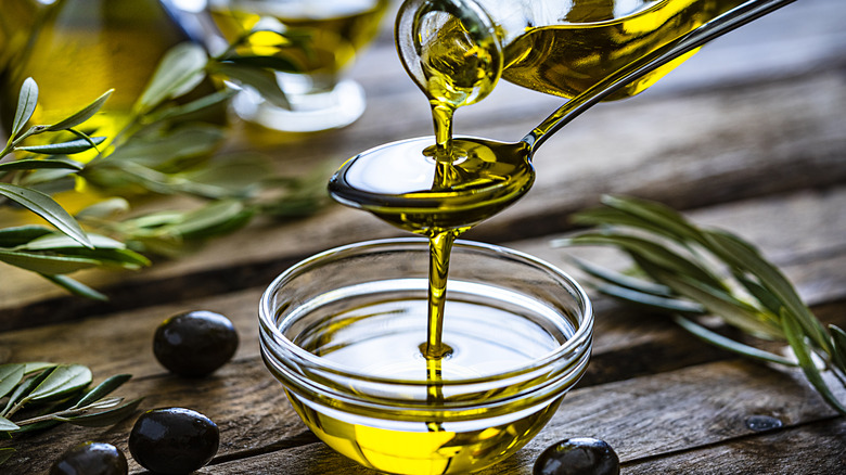 pouring olive oil onto spoon