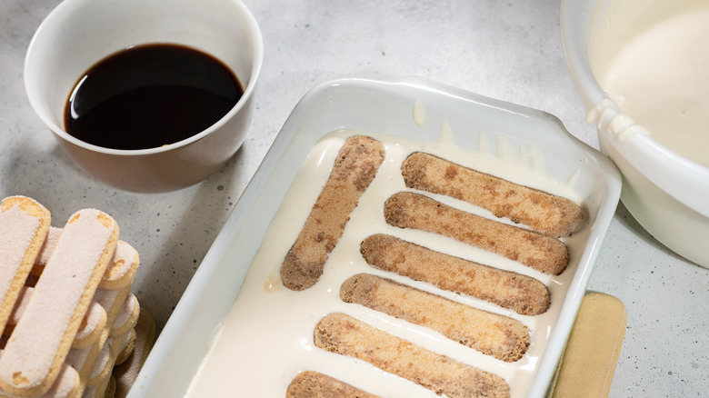 Forming tiramisu with biscuits