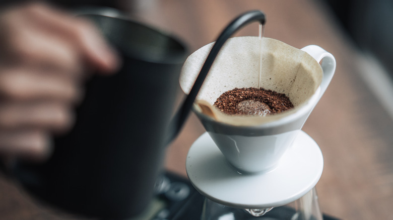 Pouring water through coffee filter