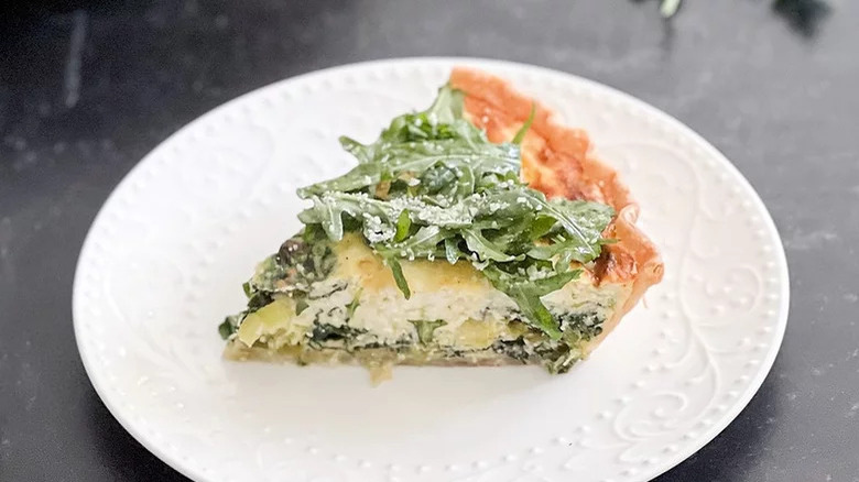 Slice of quiche on plate