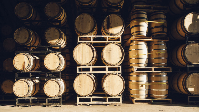 a warehouse with stacks of oak whiskey barrels