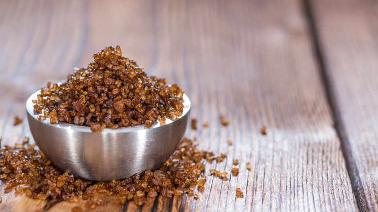 a metal bowl filled with smoked sea salt