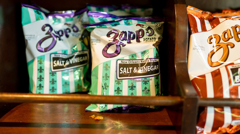 Bags of Zapp's potato chips on a shelf