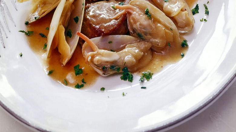 Clams with pork and sauce on a plate