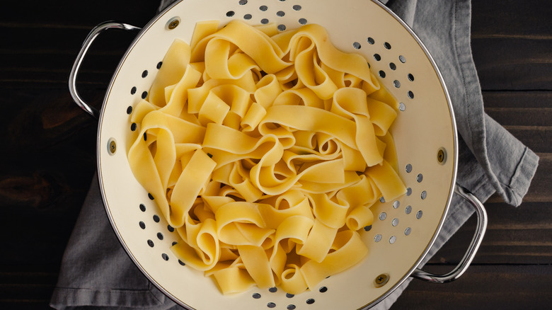 Broad noodles in a colander