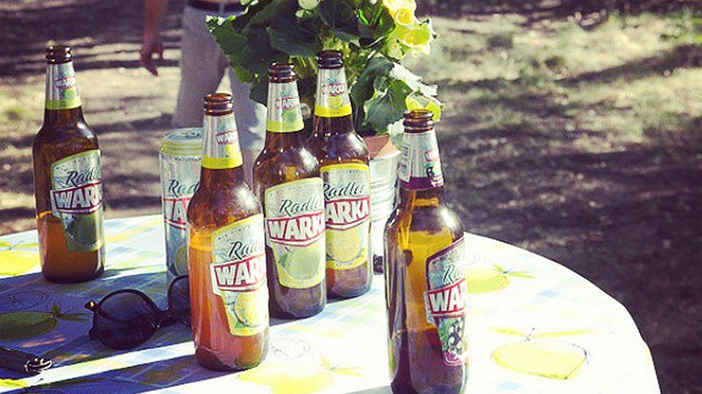 Warka Radler bottles on outdoor table