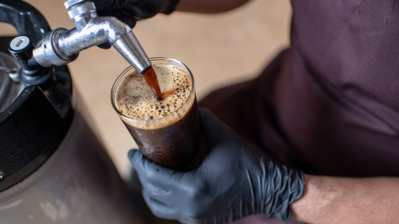 A Porter beer being poured into a glass