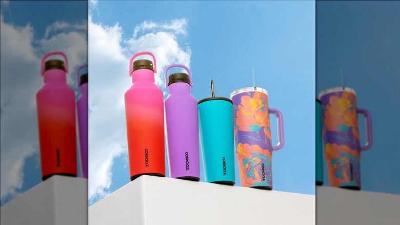 Four water bottles against sky