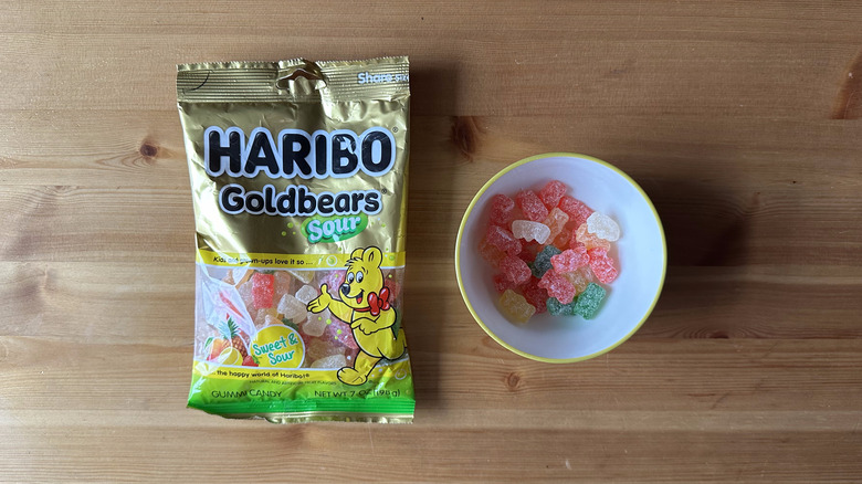 Haribo Sour Goldbears bag with bowl on wooden table