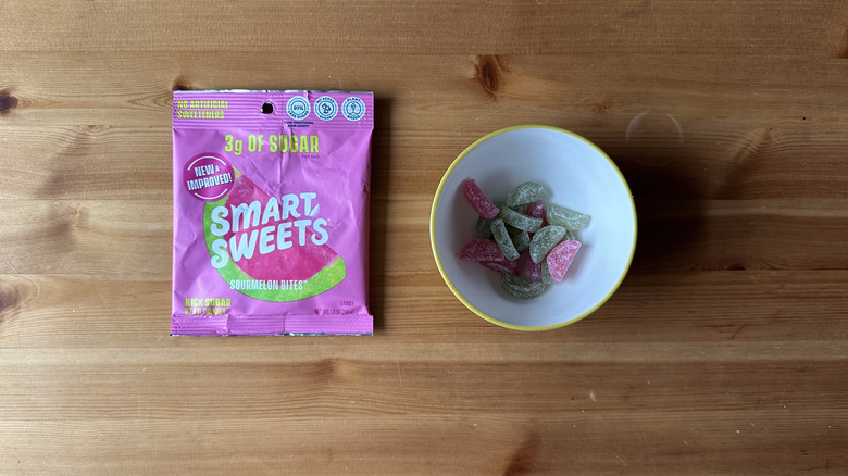 Smart Sweets Sourmelon Bites bag with bowl on wooden table