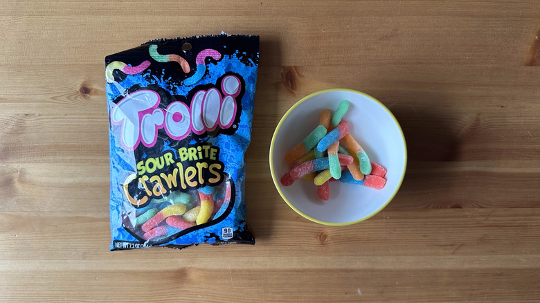 Trolli Sour Brite Crawlers bag with bowl on wooden table