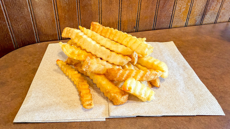 Pile of crinkle fries on a napkin