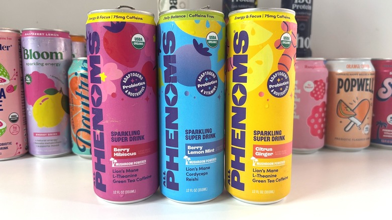 Three All Phenoms cans lined up on white table