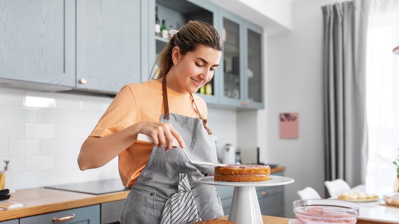 Woman finishing a cake