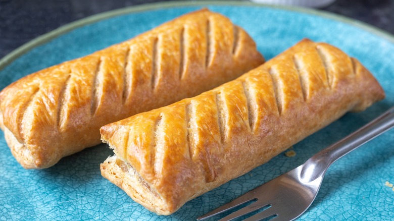 sausage rolls on blue plate