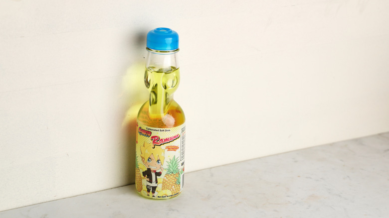 bottle of Ramune pineapple soda sitting alone