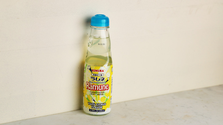 Pale yellow yuzu Ramune bottle against wall