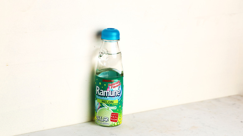 A single Ramune melon bottle against the wall