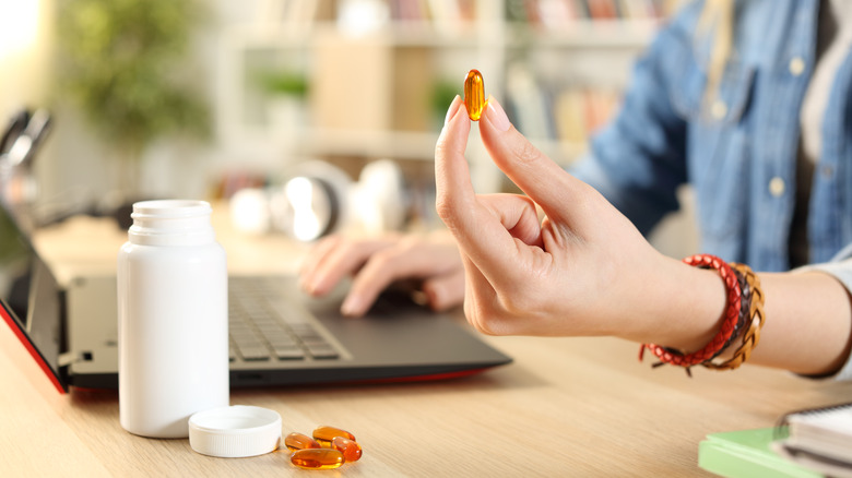 student holding pill