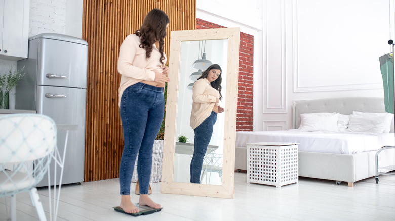 women looking at herself in mirror