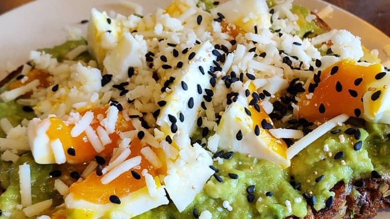 Closeup of smashed avocado on toast from Flower Child restaurant.