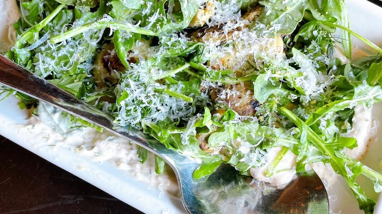 Plated salad with fresh parmesan from Olive + Ivy restaurant.