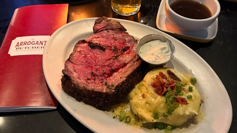 Plate of prime rib and mashed potatoes at The Arrogant Butcher.