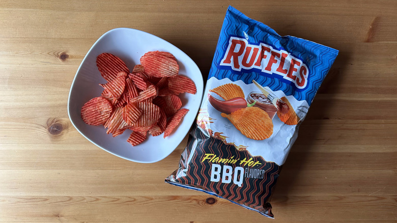 Flamin' Hot BBQ bag with a bowl of chips on a wooden table