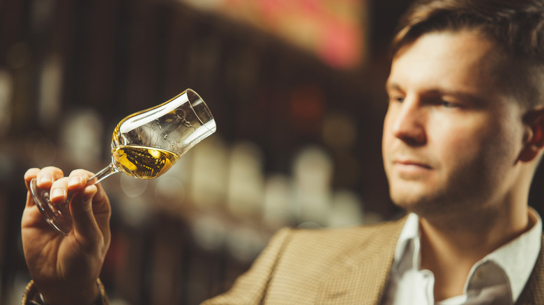 a whisky expert assessing a glass of whisky